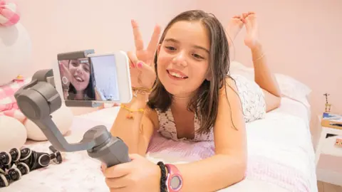 Getty Images A young girl taking a selfie