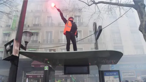 AFP/Getty A man with a flare in Paris