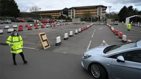 EPA A car arrives at an NHS coronavirus drive through testing facility at Chessington World of Adventure