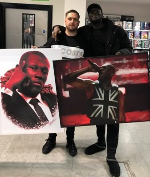 John Donaldson John Donaldson presenting Stormzy with pictures he had drawn of the musician