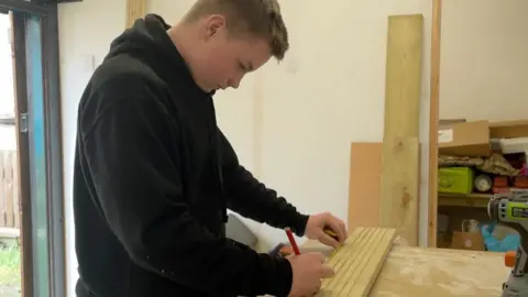 A 14-year-old in a workshop