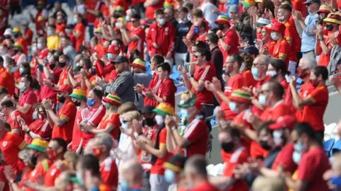 Wales fans cheer in the crowd during the international friendly football match between Wales and Albania at Cardiff City Stadium in Cardiff, South Wales, on June 5, 2021. (Photo by Geoff Caddick / AFP) (Photo by GEOFF CADDICK/AFP via Getty Images)