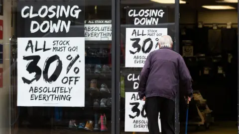 EPA-EFE/REX/Shutterstock Closing down signs at a shop in Huddersfield, West Yorkshire