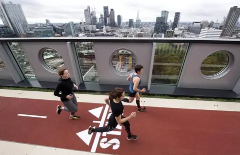 Victoria Jones/PA Wire Runners make their way along a track.