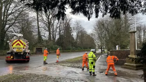 Council workers clearing the flood water away on Friday