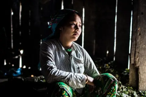 Plan International / Vincent Tremeau Dinh sits in her house