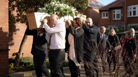 People carry a coffin