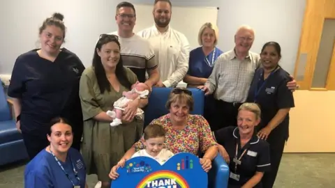 Family photo Mr Beedle's family with the new chair
