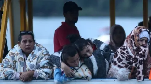 AFP/Getty Images Survivors from the sunken boat