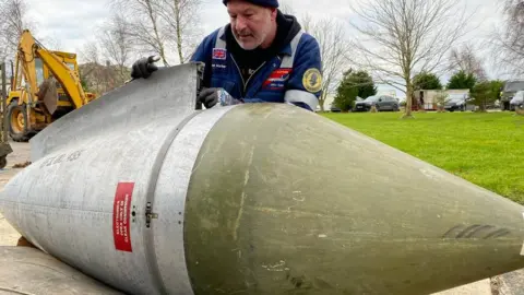 Chris Frear Volunteer working on plane part