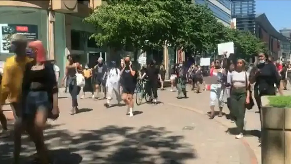 BBC Anti-racism campaigners march through Manchester city centre