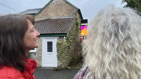 BBC Two women looking at thermal images of a home, on a mobile phone