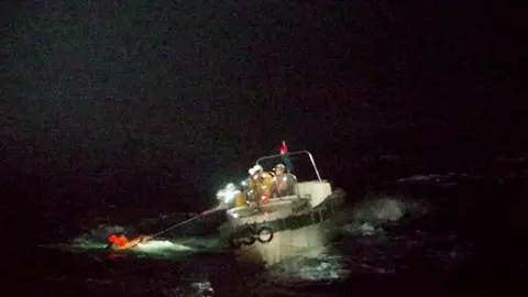 Reuters Patrol ship pulling seaman out of the water