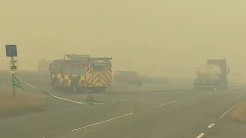 BBC Fire engine shrouded in smoke at roadside