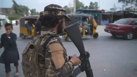 BBC Guard with gun in Jalalabad, Afghanistan