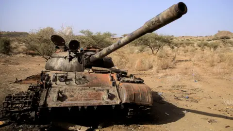 Reuters A tank destroyed in fighting between the Ethiopian National Defence Force (ENDF) and the Tigray People"s Liberation Front (TPLF)