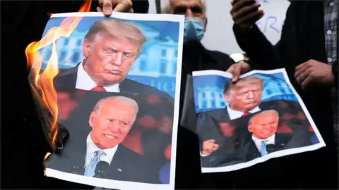 Reuters Pictures of Donald Trump and Joe Biden are burned at a protest in Tehran against the killing of top nuclear scientist Mohsen Fakhrizadeh (Nov 2020)