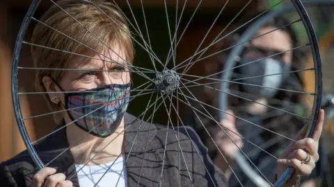 Reuters Nicola Sturgeon holds a bicycle wheel