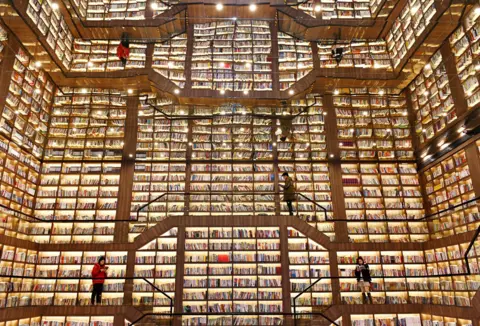 Teng Zhizhong / Getty Images People stand and read books in a giant bookstore