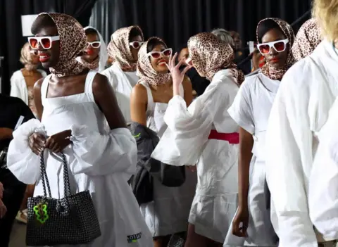 Reuters Female models wearing white, head scarves and glasses.