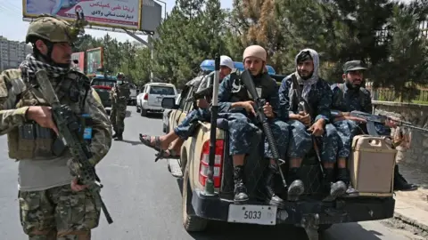 Getty Images Taliban Fateh fighter, a "special forces" unit, stands guard along with other fighters on a street in Kabul