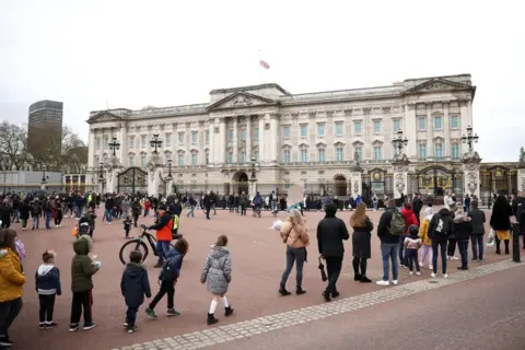 Reuters People queue outside Buckingham Palace after Britain's Prince Philip died at the age of 99. 10 April 2021.