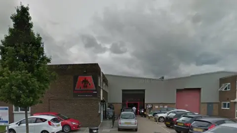 Google Gym unit on industrial estate, showing car park and AB Salute sign