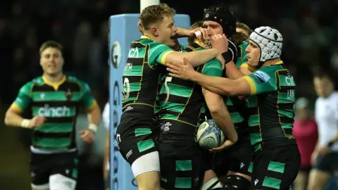Getty Images Northampton Saints celebrate a try against Saracens on 29 March 2024