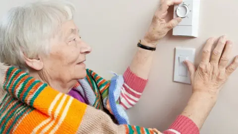 Getty Images woman using thermostat