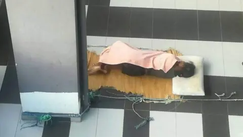 Por Cheng Han Adelina sleeps outside on her employer's veranda