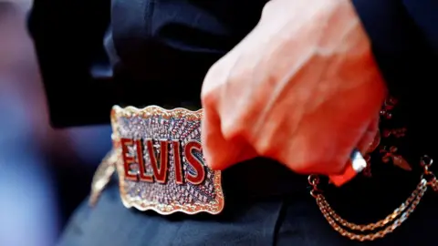 Reuters Baz Luhrmann showing his Elvis belt at the Cannes Film Festival