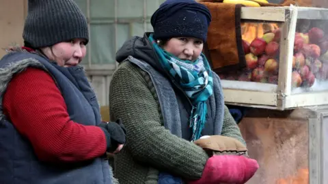 EPA Kyrgyz women trade in the cold at a bazaar in Bishkek, Kyrgyzstan