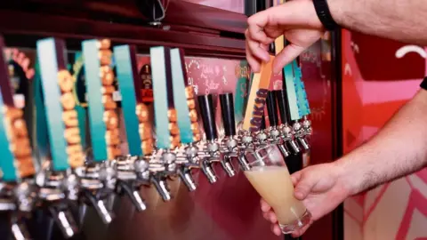 (A)manda Parkinson/BBC A man pouring a pint of laksa seltzer