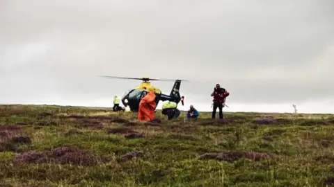 Oldham Mountain Rescue Team People being helped to safety