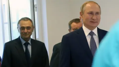 Getty Images Suleiman Kerimov (left) and Vladimir Putin in Sochi, Russia, in 2019