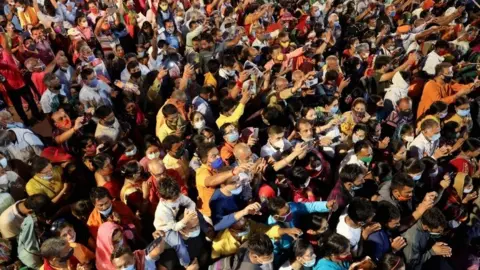 Devotees gather for evening prayer on the banks of the Ganges river during Kumbh Mela, or the Pitcher Festival, amidst the spread of the coronavirus disease (COVID-19), in Haridwar, India, April 13,