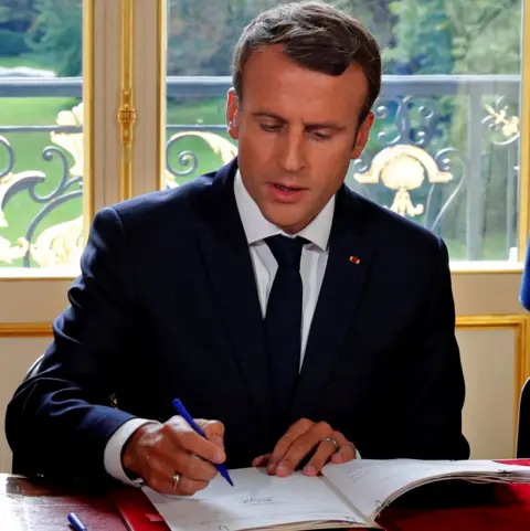Reuters Mr Macron signs labour reforms into law (22 Sept)