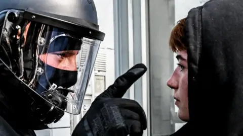 FILIP SINGER/EPA-EFE/REX/Shutterstock  A policeman argues with a participant of a left wing protest in solidarity with Lina E. in Berlin, Germany, 31 May 2023