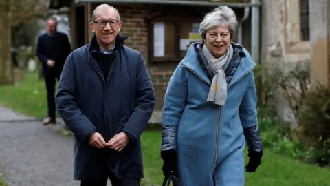 Reuters Prime Minister Theresa May and her husband Philip leave church