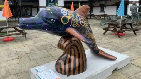 BBC A photo of a dolphin statue