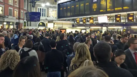 PA Passengers at Victoria station in London