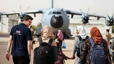 FCDO Fraser walking towards plane