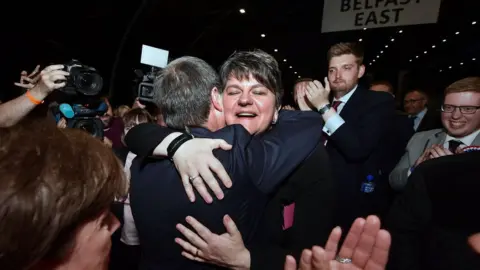 Getty Images DUP leader Arlene Foster is hugged by deputy leader Nigel Dodds at the count centre in Belfast, Northern Ireland