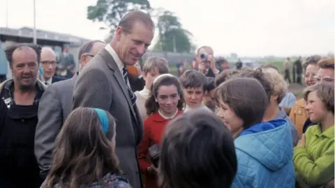 PA The Duke of Edinburgh talking to children during an impromptu visit to the Scottish National Caravan Rally in 1969