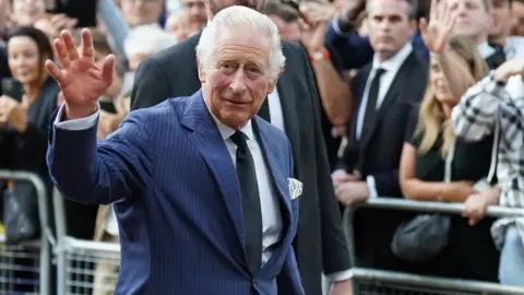 PA Media King Charles waves to the crowd