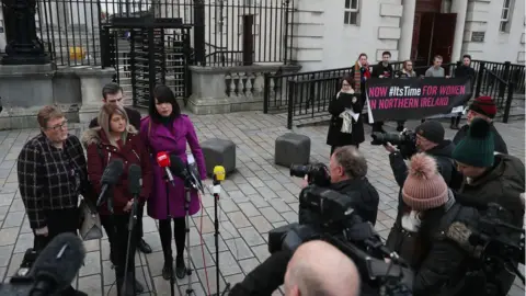 PA Sarah Ewart was accompanied to court by her mother and Grainne Teggart of Amnesty International