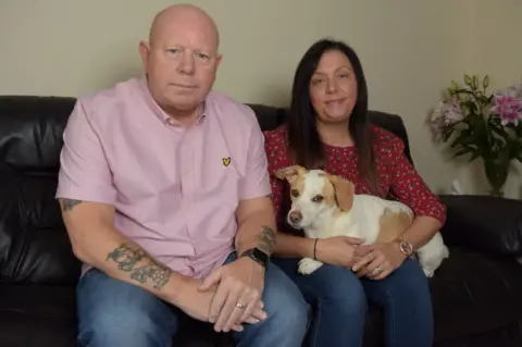 Michael Scott/Caters News Neil Walker, his dog Stanley and his wife Amanda