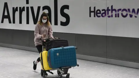 EPA Passenger and sign at Heathrow