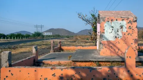 AFP via Getty Images Bullet holes are seen after a battle between the CJNG and Los Viagras cartels in Aguililla