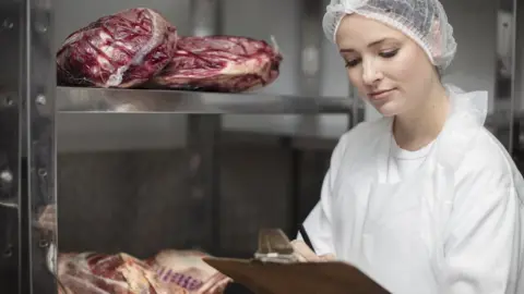 Getty Images Woman checking meat imports